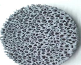 Silicon carbide ceramic foam filter disc - close-up showing open-pore foam structure