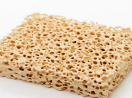 Zirconia ceramic foam filter square block - yellow color, top view showing open-pore structure